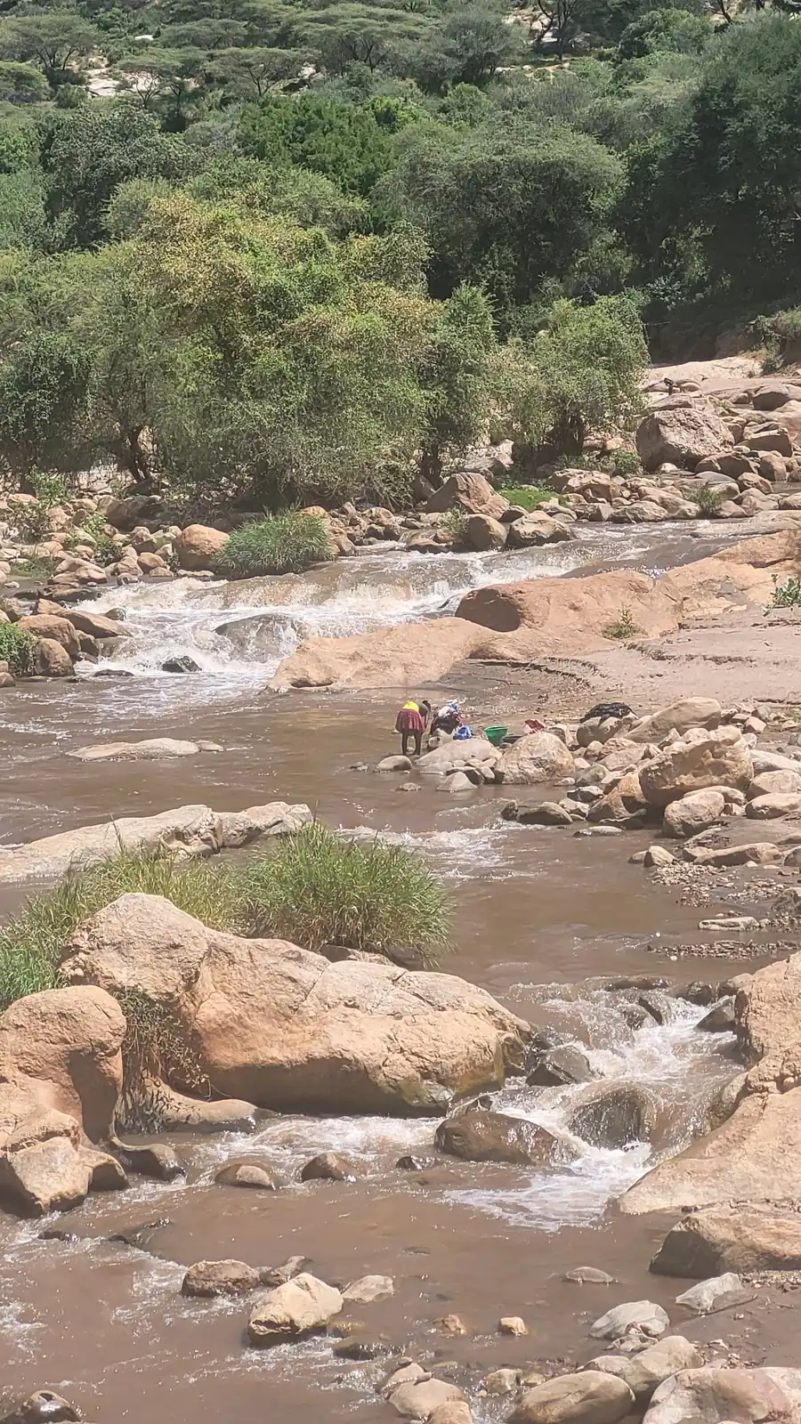 A wide, rocky riverbed in the dry season