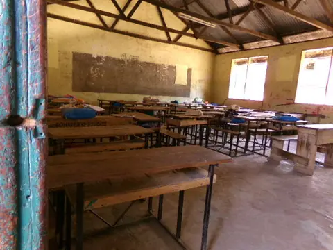 Empty classroom, desks and benches in rows