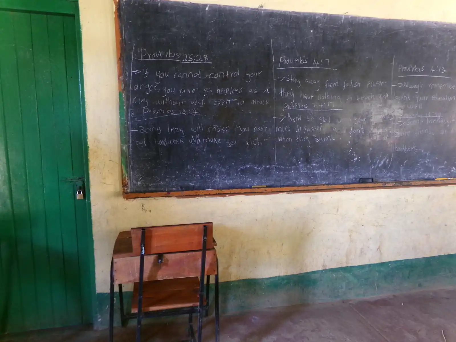 A single desk against the classroom wall