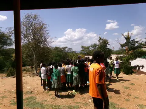 Pupils gathered in a circle outdoors