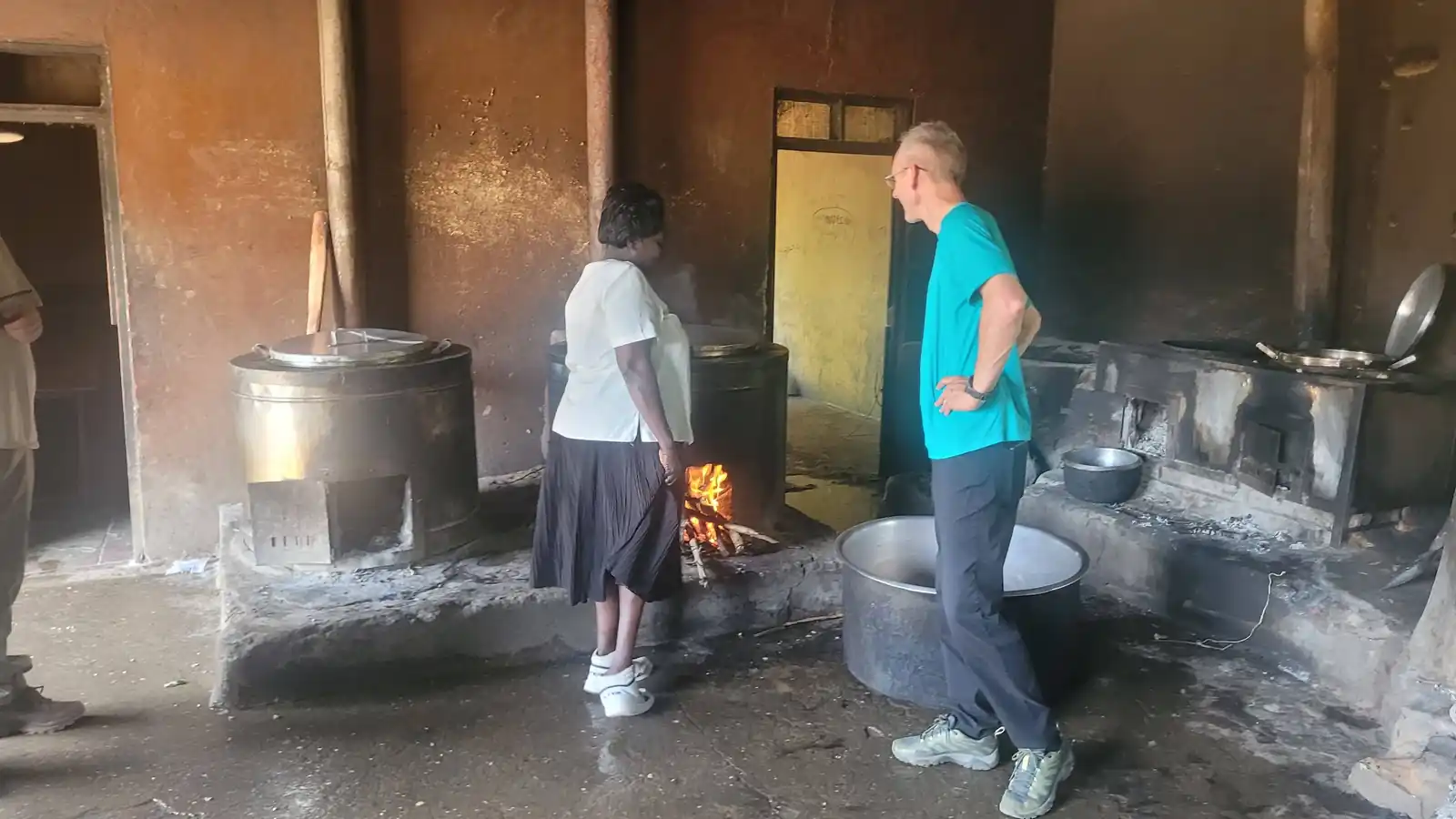 Tending the fire beneath the cooking drums