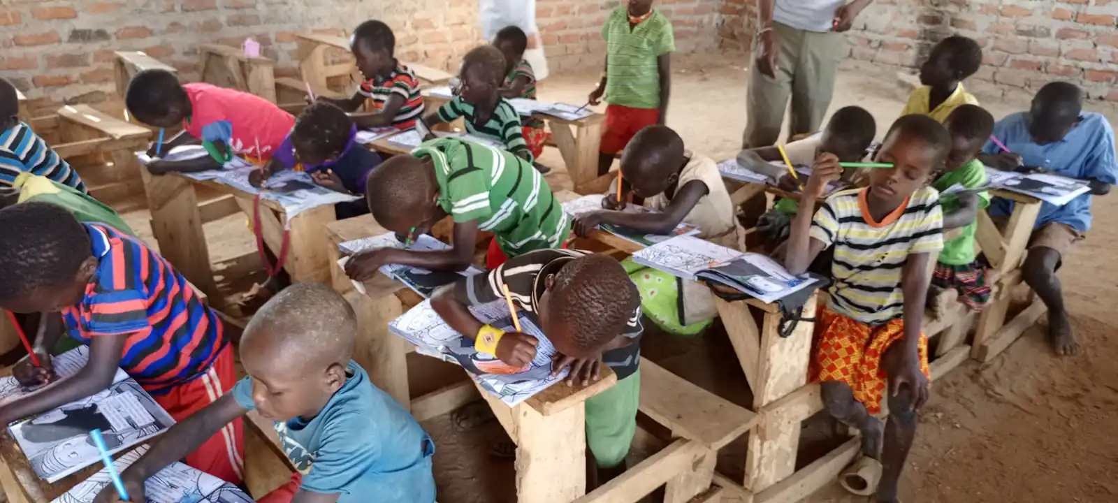 A class working through illustrated Bible workbooks